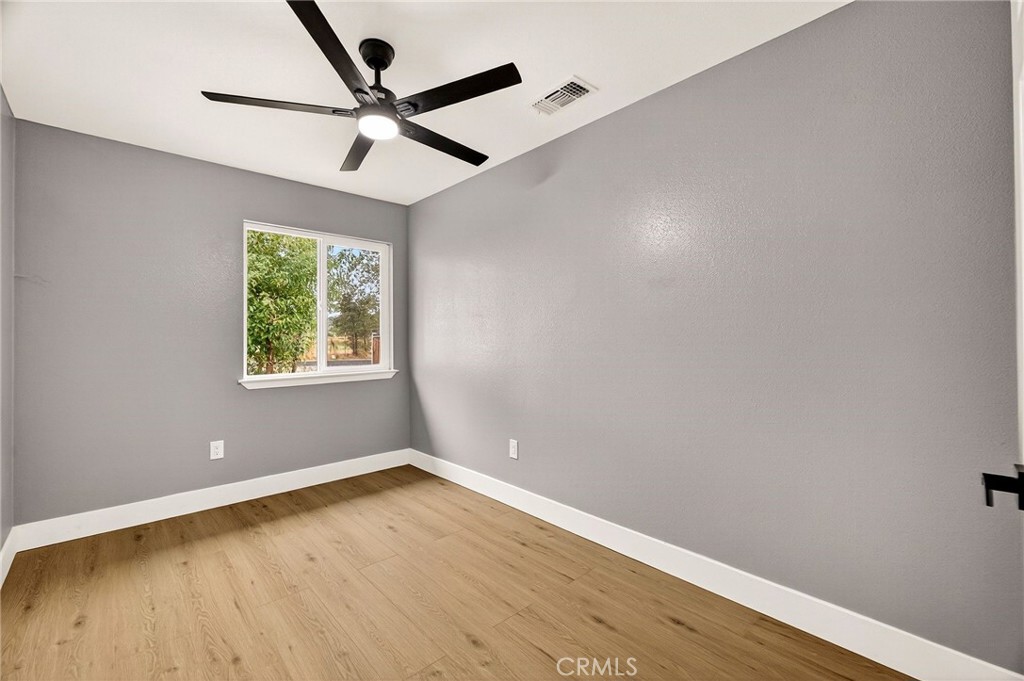 7040 Fulton Avenue Palermo, CA 95968 - Photo 33 of 53 an empty room with wooden floor and windows