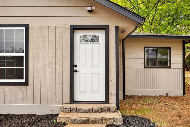 a view of empty room with wooden floor and fireplace