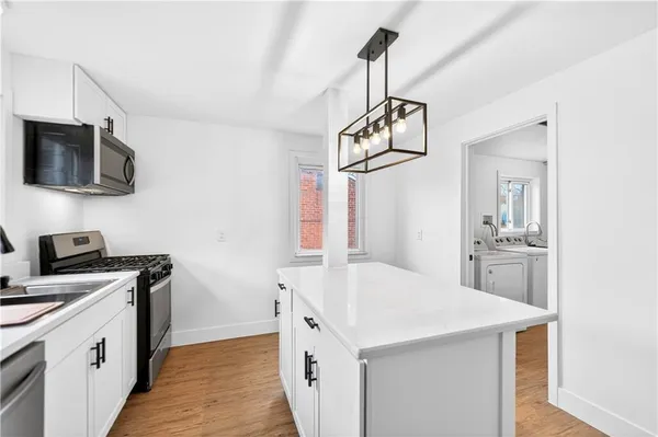 a kitchen with a sink a stove and microwave