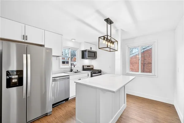 a kitchen with a sink stove and microwave