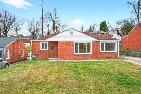 a front view of a house with a yard