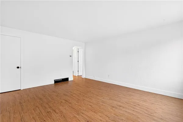 a view of an empty room and wooden floor