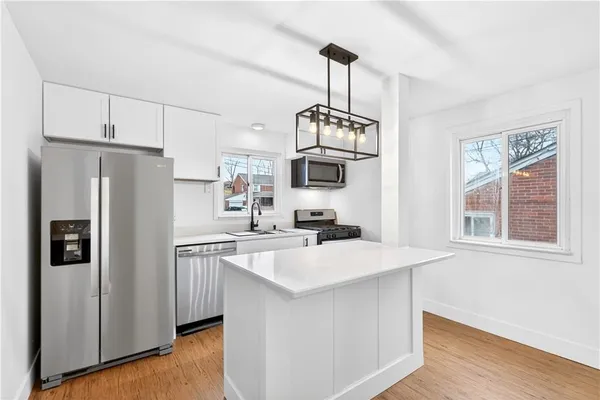 a kitchen with stainless steel appliances a sink stove and refrigerator
