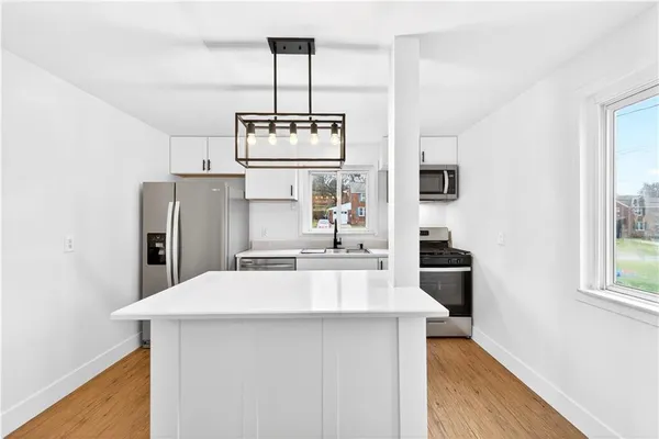 a kitchen with stainless steel appliances a sink stove and refrigerator
