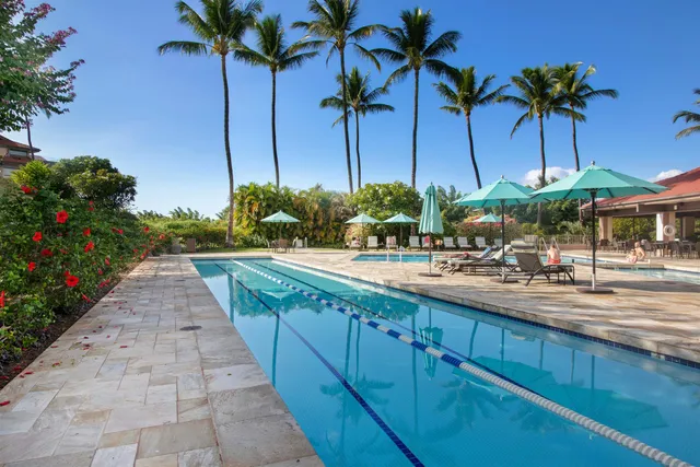 a view of a backyard and swimming pool