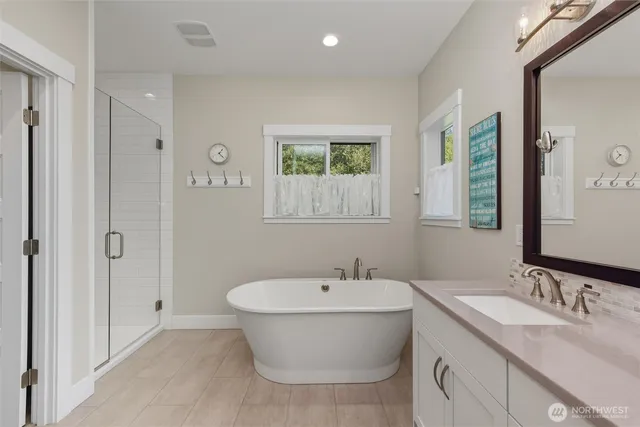 a bathroom with a granite countertop sink mirror vanity and toilet