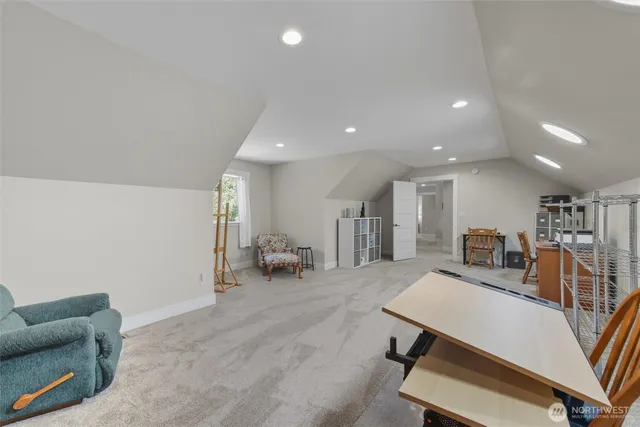 a view of a kitchen with furniture and a refrigerator