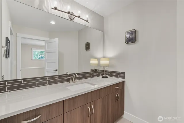 a bathroom with a sink a vanity and a mirror