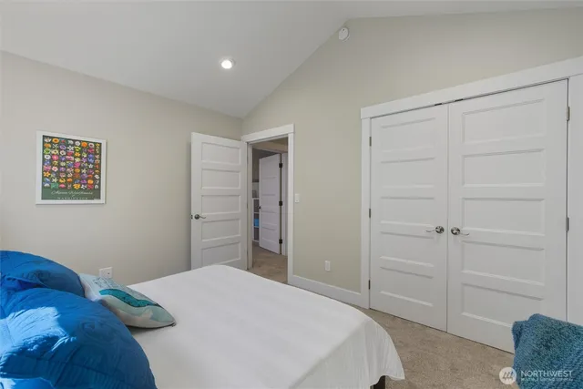 a bedroom with a bed and a couch