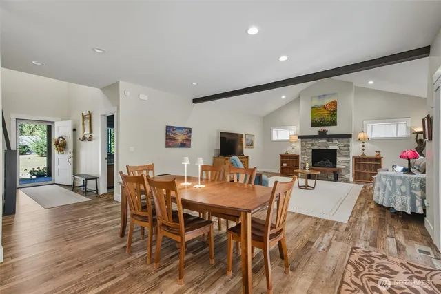 a living room with fireplace furniture and a wooden floor