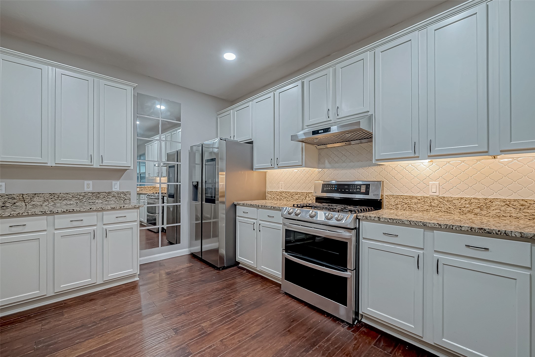22922 Montclair Park Lane Spring, TX 77373 - Photo 21 of 46 a kitchen with stainless steel appliances granite countertop wooden cabinets and a stove top oven
