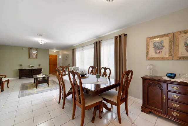 a kitchen with stainless steel appliances granite countertop a refrigerator a sink a stove and white cabinets