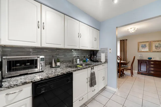 a view of a dining room with furniture and a flat screen tv