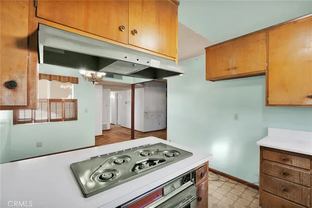 a stove top oven sitting inside of a kitchen