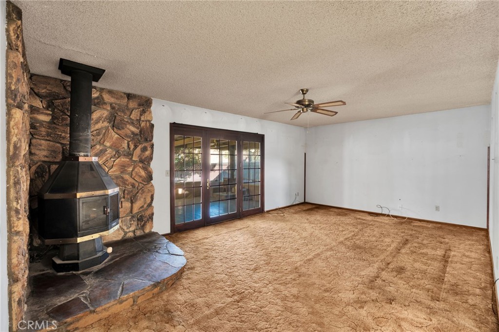 1405 Piute Street Barstow, CA 92311 - Photo 12 of 32 a view of a livingroom with fireplace and window