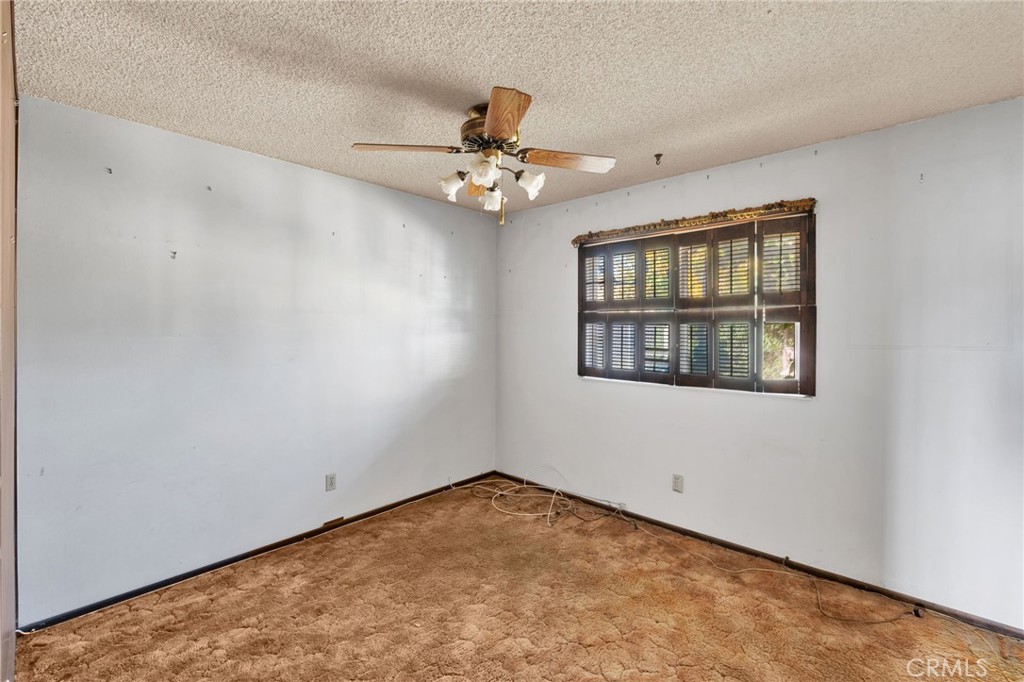1405 Piute Street Barstow, CA 92311 - Photo 18 of 32 an empty room with ceiling fan and window