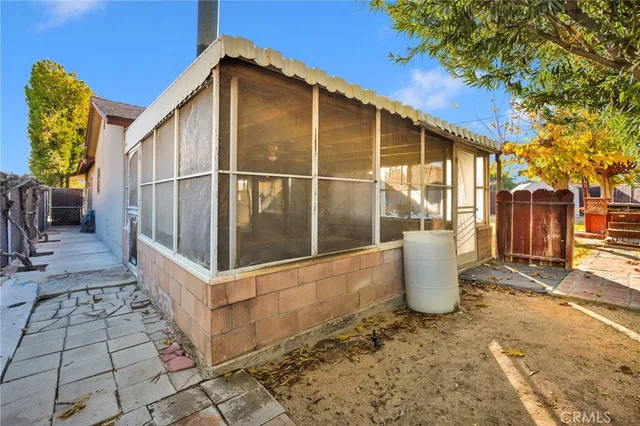 a view of a small house with backyard