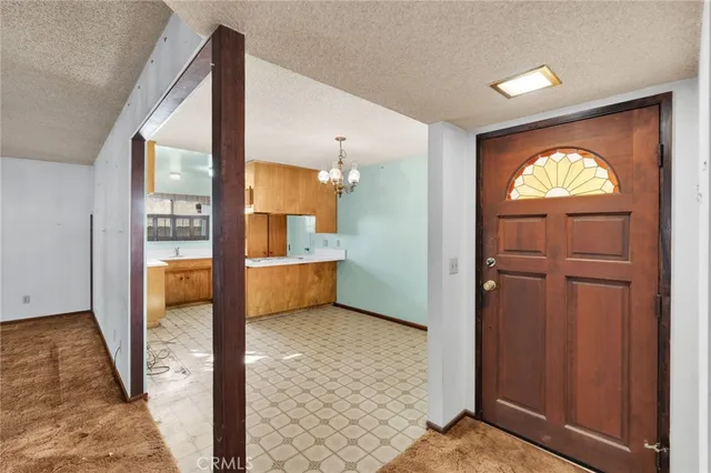 a view of a hallway with wooden floor and a bathroom