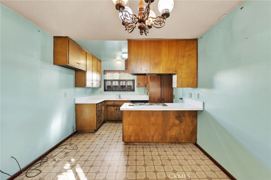1405 Piute Street Barstow, CA 92311 - Photo 7 of 32 a kitchen with stainless steel appliances a stove refrigerator sink and cabinets