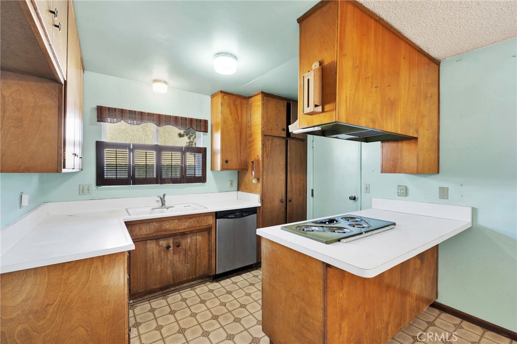 1405 Piute Street Barstow, CA 92311 - Photo 8 of 32 a kitchen with stainless steel appliances kitchen island a sink stove and refrigerator