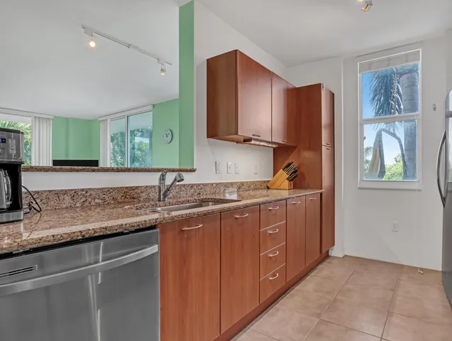 a kitchen with stainless steel appliances granite countertop a stove and a microwave