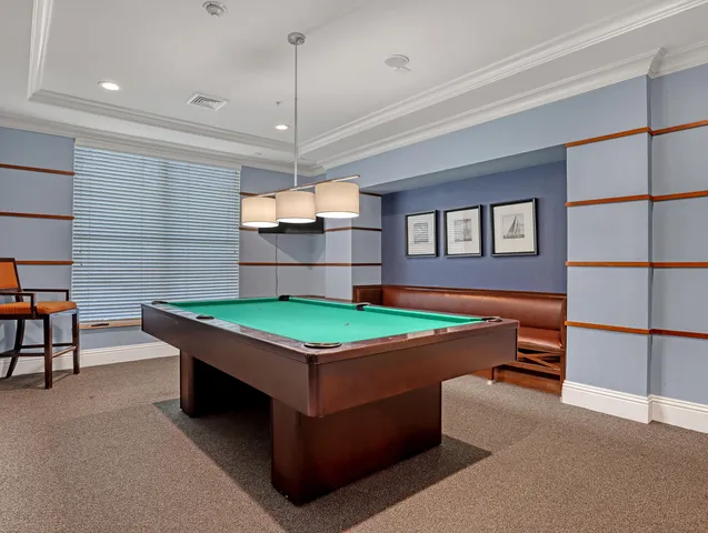 a media room with lots of chairs and mirrors