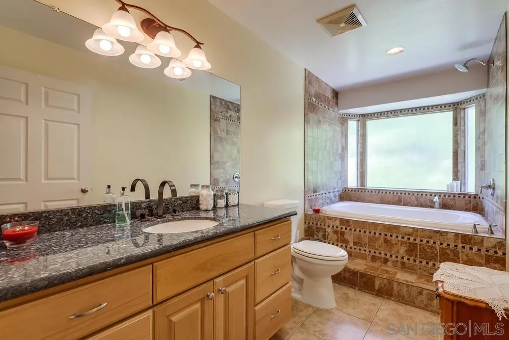 460 Pile Street Ramona, CA 92065 - Photo 13 of 25 a bathroom with a double vanity sink and a toilet
