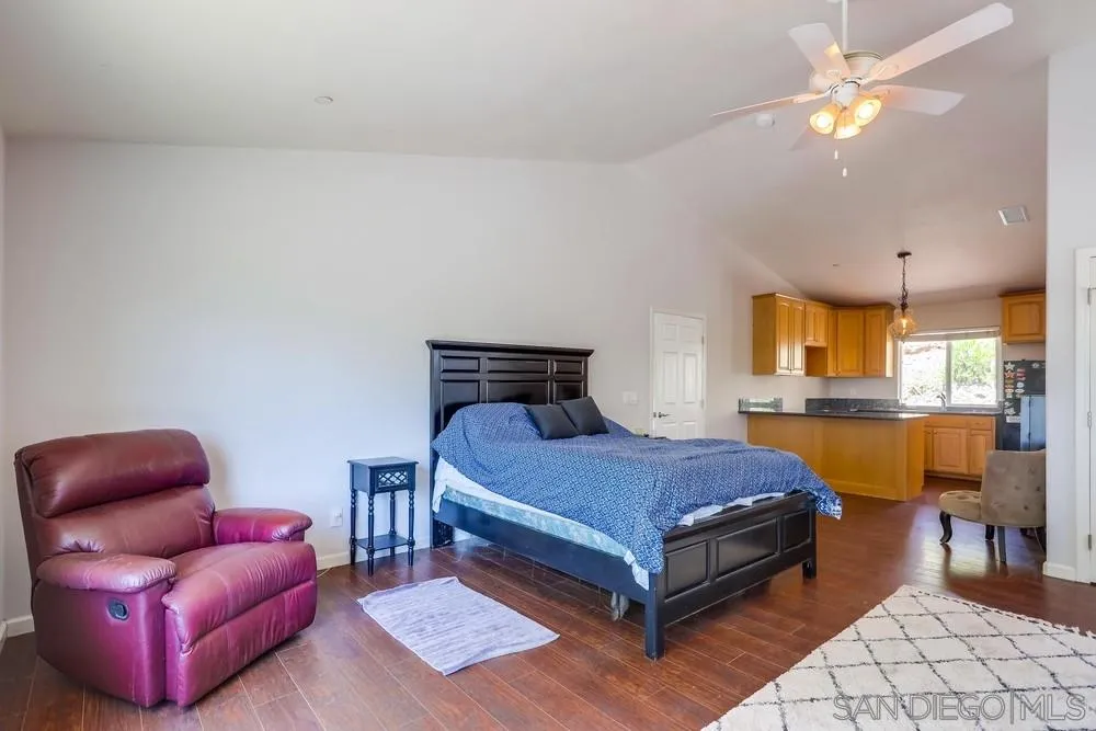 460 Pile Street Ramona, CA 92065 - Photo 15 of 25 a bedroom with furniture and a chandelier