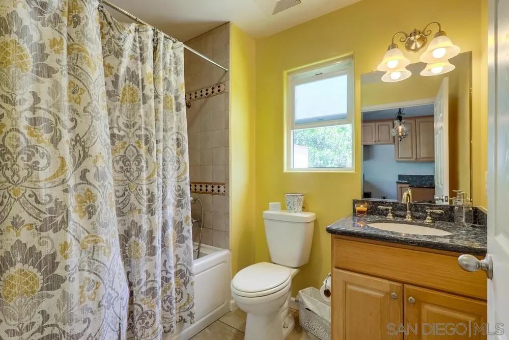 460 Pile Street Ramona, CA 92065 - Photo 17 of 25 a bathroom with a granite countertop toilet sink and mirror