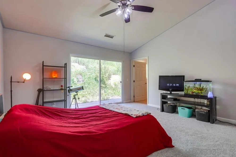 460 Pile Street Ramona, CA 92065 - Photo 18 of 25 a bed room with a bed and a chandelier