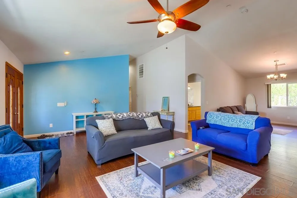 460 Pile Street Ramona, CA 92065 - Photo 4 of 25 a living room with furniture a rug and a chandelier