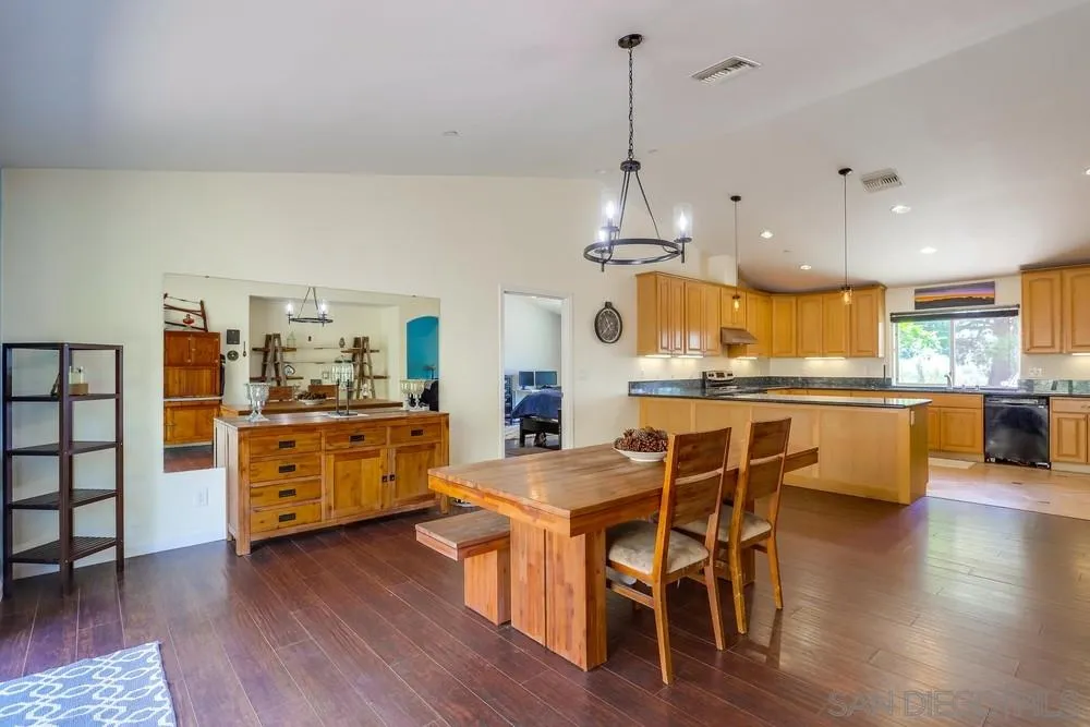 460 Pile Street Ramona, CA 92065 - Photo 8 of 25 a view of a dining room and livingroom with furniture wooden floor kitchen view
