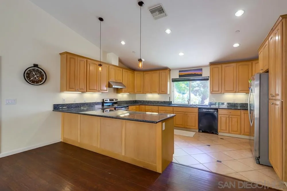 460 Pile Street Ramona, CA 92065 - Photo 9 of 25 a kitchen with granite countertop a sink a counter space appliances and cabinets