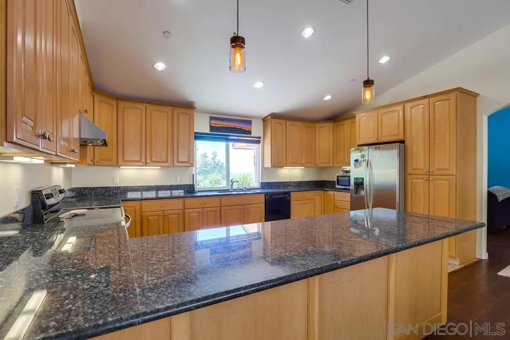460 Pile Street Ramona, CA 92065 - Photo 10 of 25 a kitchen with stainless steel appliances granite countertop a sink a stove and a refrigerator