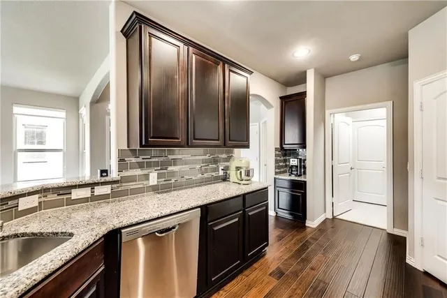 a kitchen with stainless steel appliances granite countertop a sink stove and oven