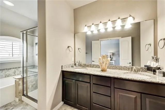 a bathroom with a sink double vanity and a mirror