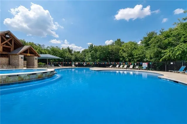 a view of a swimming pool with an outdoor space and seating area
