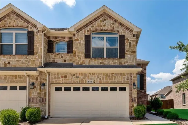 a front view of a building with a yard