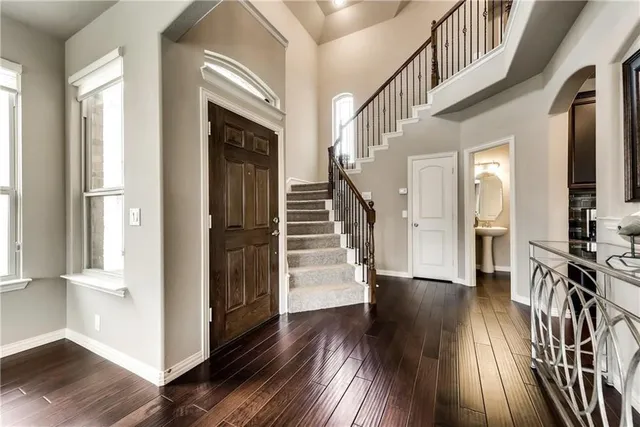 a view of a entryway with wooden floor and stairs