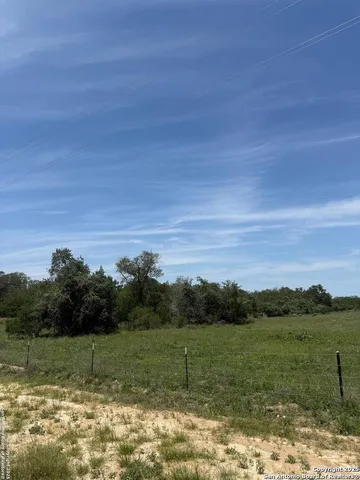 a view of a lake with green valley