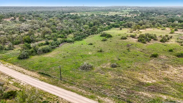 a view of a field with an trees