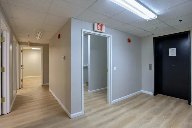 a view of a room with wooden floor