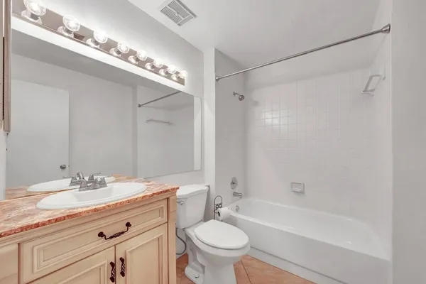 a view of a livingroom with wooden floor and kitchen space
