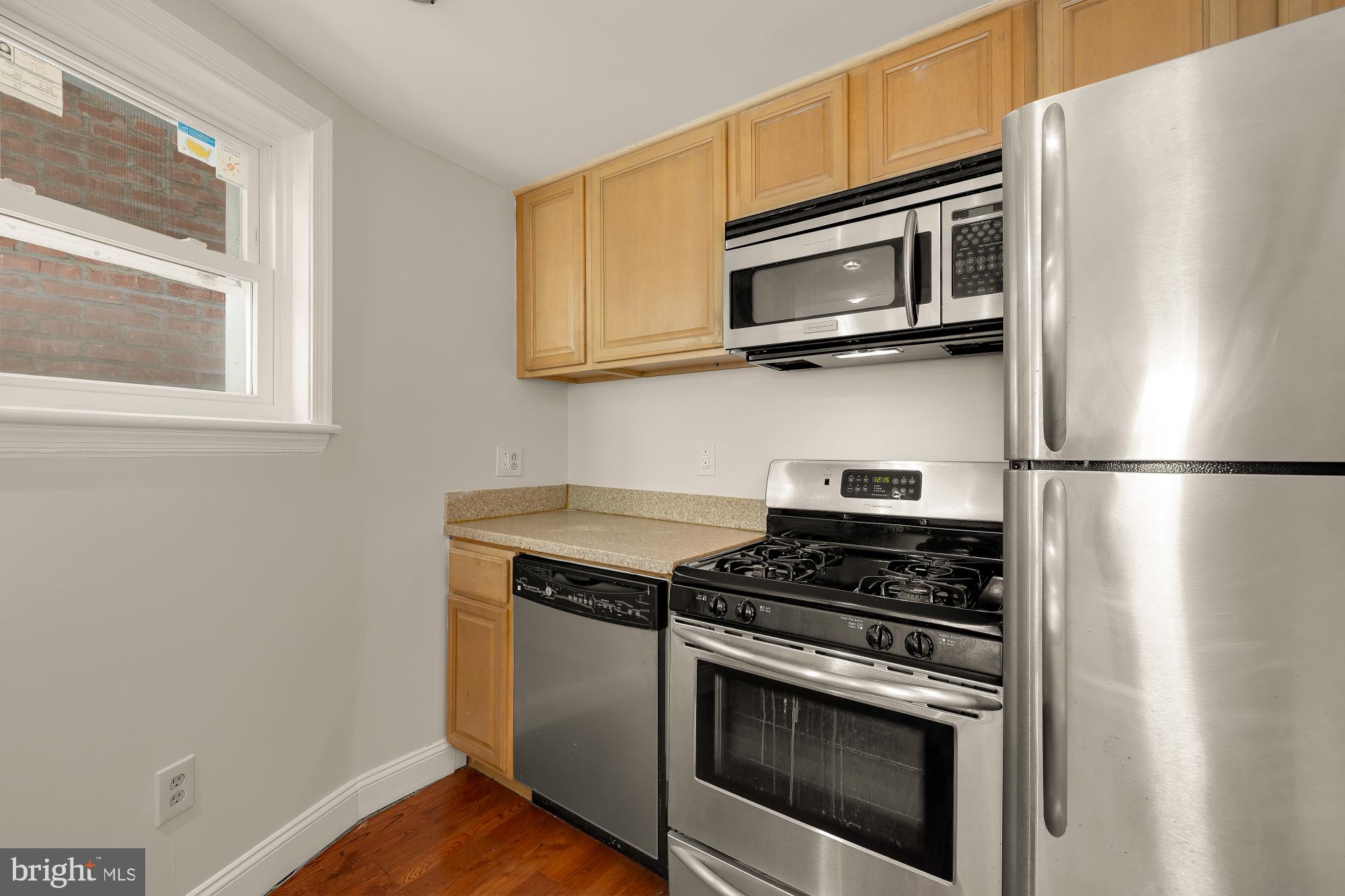601 L Street Northeast Washington, DC 20002 - Photo 27 of 47 a kitchen with stainless steel appliances a stove microwave and sink