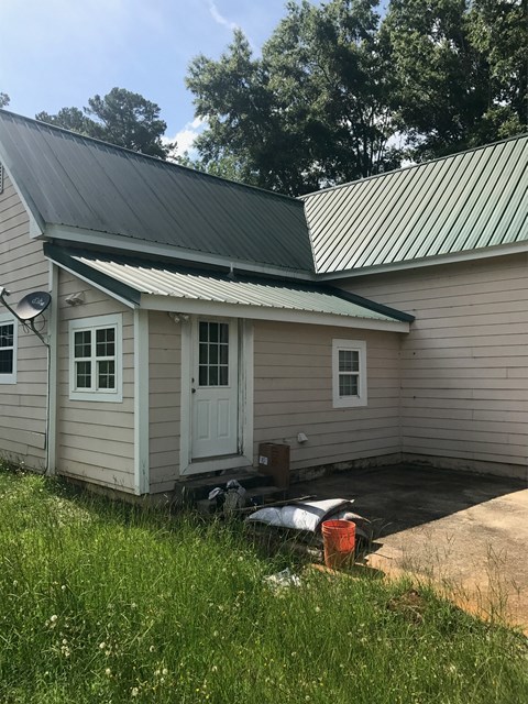 195 Joe Chambers Road Forsyth, GA 31029 - Photo 3 of 9 a backyard of a house with wooden fence table and chairs