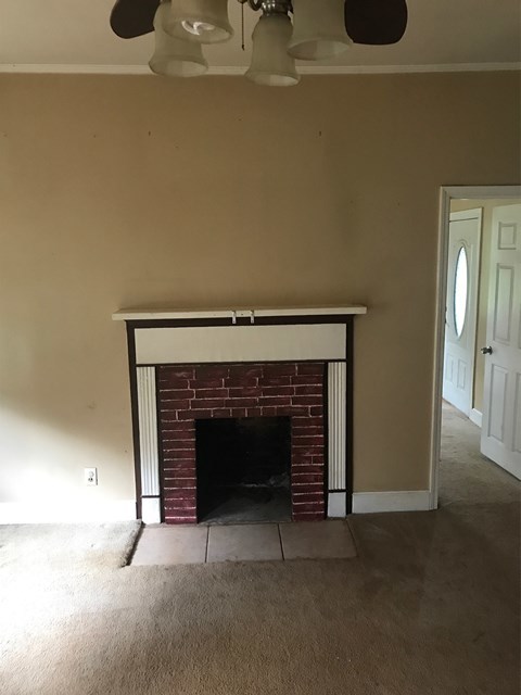 195 Joe Chambers Road Forsyth, GA 31029 - Photo 6 of 9 a living room with furniture and a fireplace