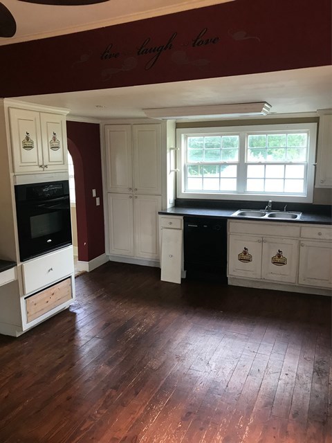 195 Joe Chambers Road Forsyth, GA 31029 - Photo 9 of 9 a kitchen with granite countertop a stove a sink and a refrigerator