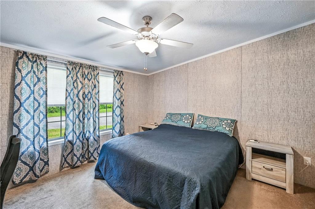 73 South Summit Road, Unit 503 Greenville, PA 16125 - Photo 15 of 36 a bedroom with a bed and a chandelier