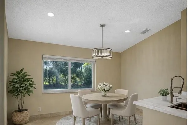a view of a kitchen with a stove wooden floor and a chandelier