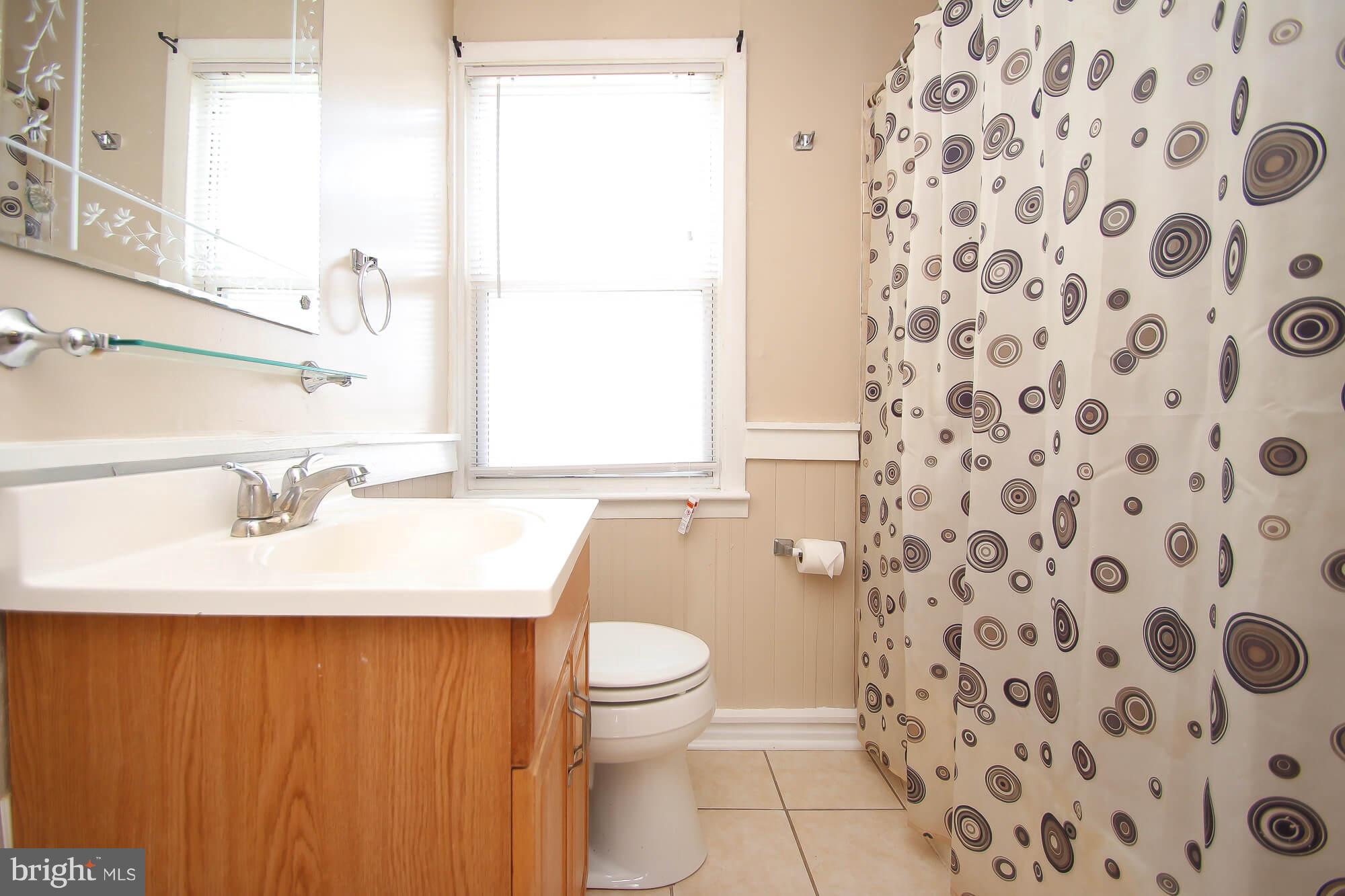 8036 Wynbrook Road Baltimore, MD 21224 - Photo 17 of 30 a bathroom with a sink toilet and shower